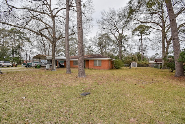 view of yard featuring a carport and fence