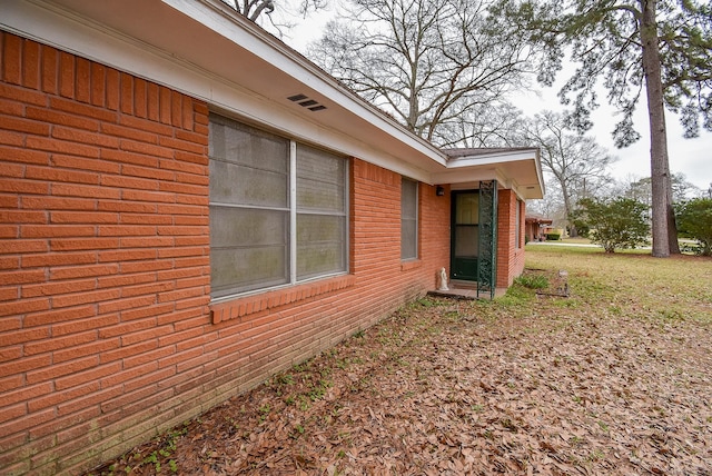 view of side of home with brick siding