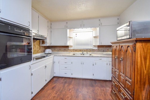 kitchen with electric stovetop, light countertops, stainless steel microwave, oven, and under cabinet range hood