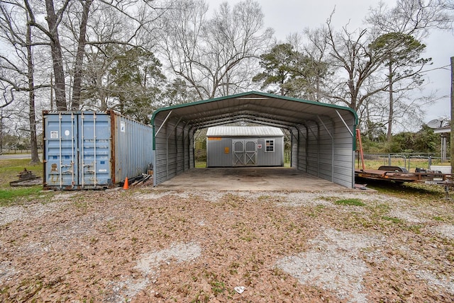 view of parking / parking lot featuring a carport, driveway, and a storage shed