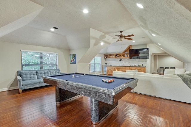 recreation room with hardwood / wood-style flooring, vaulted ceiling, a textured ceiling, and pool table