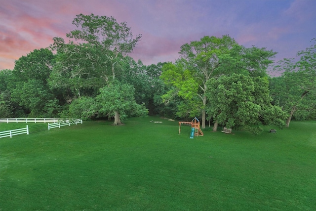 view of yard with a playground and fence