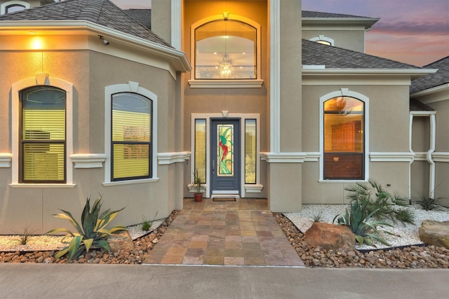 property entrance with stucco siding