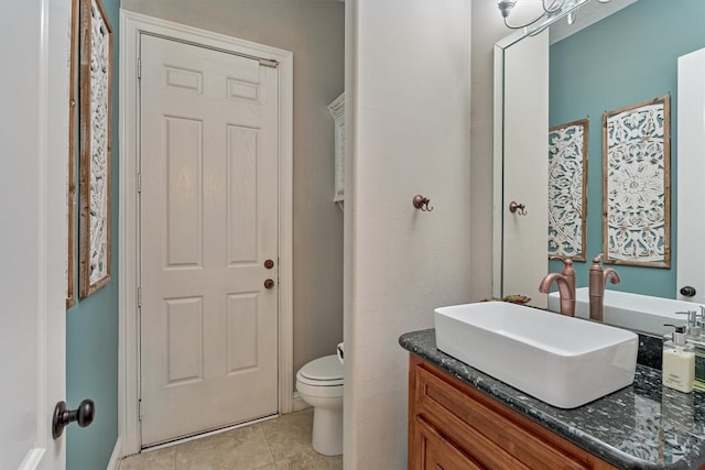 bathroom featuring toilet, tile patterned flooring, and vanity