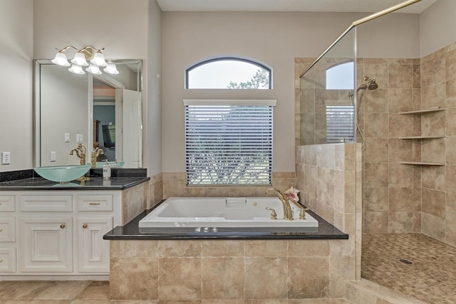 bathroom with a bath, a wealth of natural light, tiled shower, and vanity