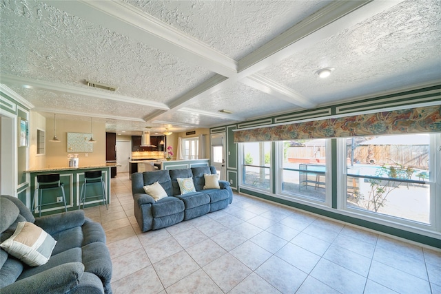 living room with crown molding, light tile patterned floors, visible vents, coffered ceiling, and beamed ceiling