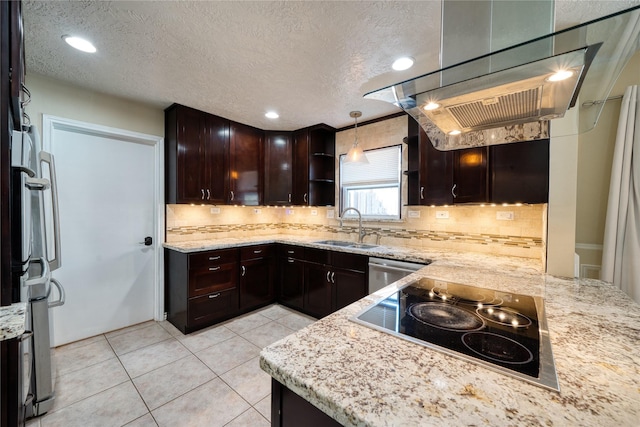 kitchen featuring dark brown cabinetry, light tile patterned floors, appliances with stainless steel finishes, light stone countertops, and a sink