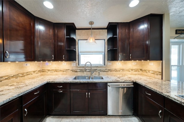 kitchen with dark brown cabinetry, light stone countertops, stainless steel dishwasher, open shelves, and a sink