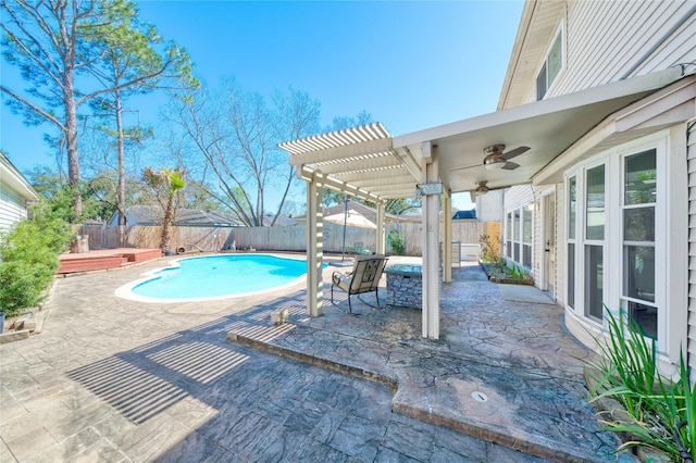 view of pool with a patio, a fenced backyard, a ceiling fan, and a pergola