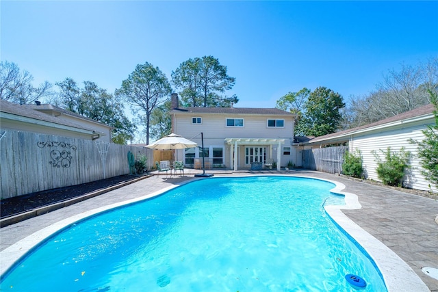 view of swimming pool featuring a fenced in pool, a patio area, and a fenced backyard