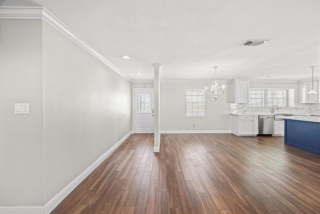 unfurnished living room featuring plenty of natural light, crown molding, visible vents, and dark wood-style flooring