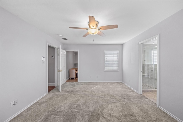 empty room featuring visible vents, baseboards, ceiling fan, and carpet flooring