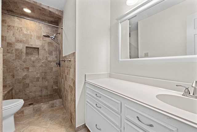 full bathroom featuring toilet, a shower stall, tile patterned flooring, and vanity