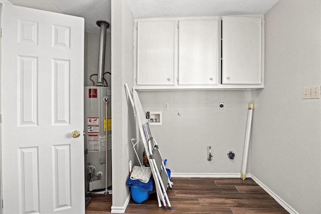 laundry room featuring hookup for a washing machine, baseboards, water heater, cabinet space, and dark wood-style floors