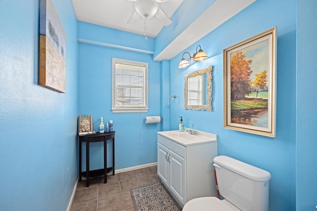 bathroom featuring tile patterned flooring, baseboards, vanity, and toilet