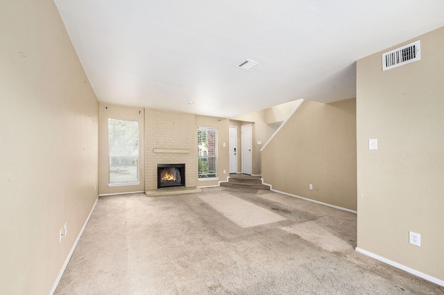 unfurnished living room featuring stairs, carpet flooring, visible vents, and baseboards