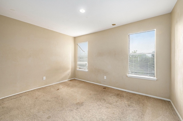 empty room with baseboards and carpet flooring