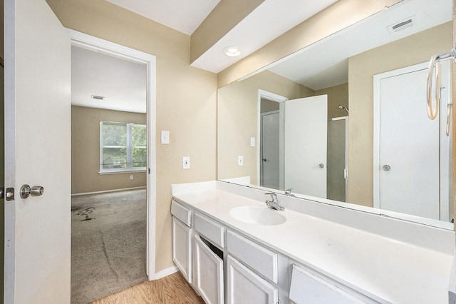 bathroom featuring baseboards, visible vents, and vanity