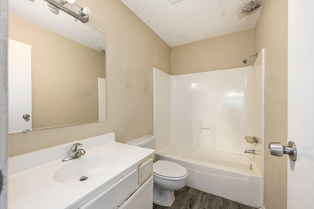 full bathroom featuring washtub / shower combination, vanity, toilet, and wood finished floors