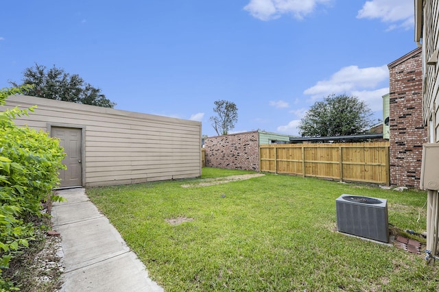 view of yard featuring central AC unit, an outdoor structure, and fence