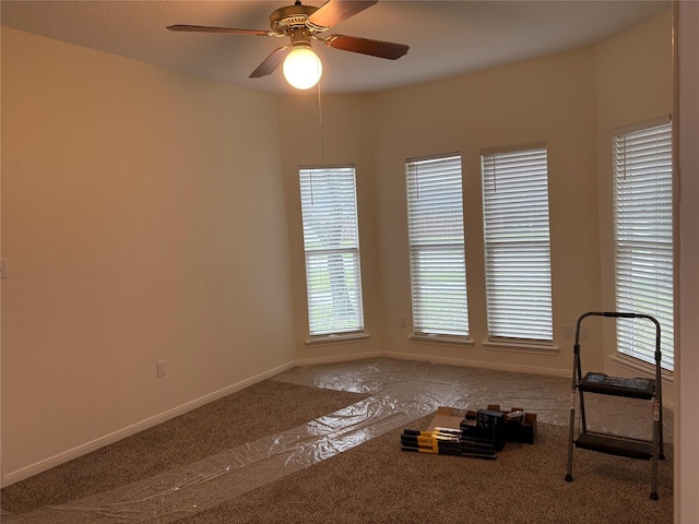 interior space featuring baseboards and ceiling fan