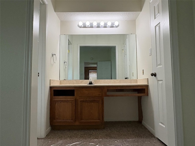 bathroom featuring a textured ceiling and vanity