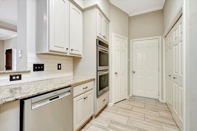 kitchen with tasteful backsplash, appliances with stainless steel finishes, light stone countertops, wood tiled floor, and crown molding