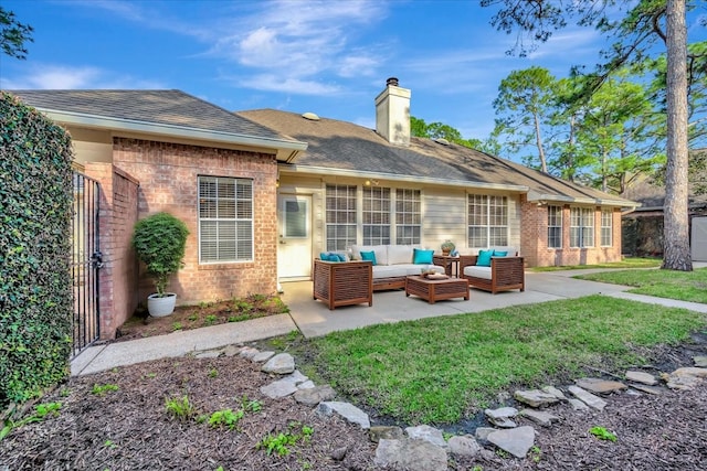 rear view of house with a patio area, brick siding, a chimney, and an outdoor hangout area