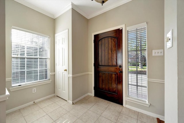 entryway with ornamental molding, plenty of natural light, baseboards, and tile patterned floors