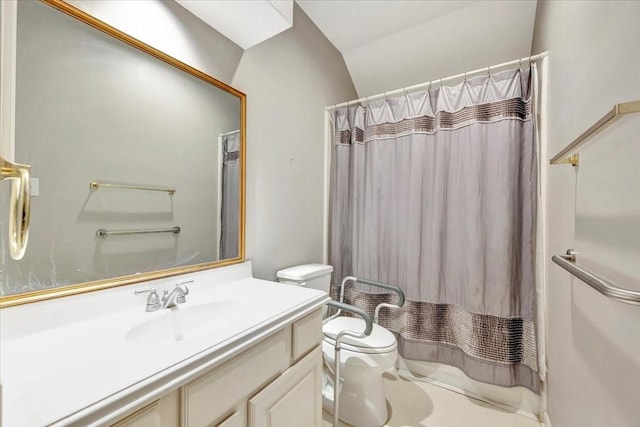 bathroom with lofted ceiling, curtained shower, vanity, and toilet