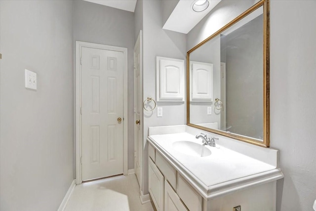 bathroom with vanity and baseboards