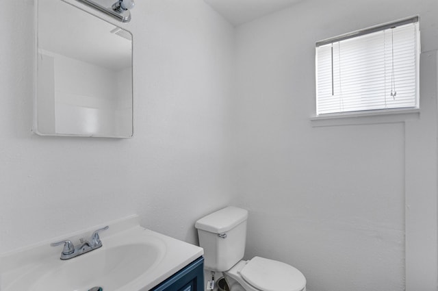 bathroom featuring toilet and vanity