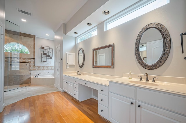 full bathroom with a bath, a sink, visible vents, and crown molding