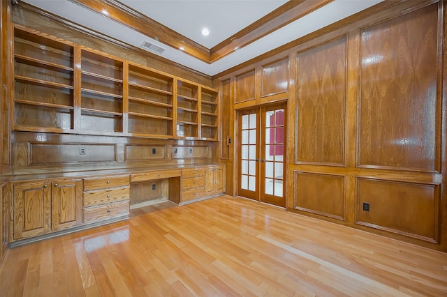 unfurnished office with visible vents, french doors, light wood-type flooring, built in study area, and crown molding