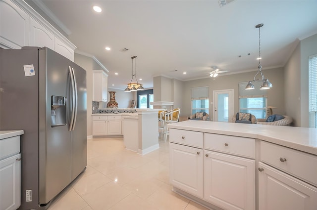 kitchen featuring recessed lighting, white cabinets, light countertops, stainless steel fridge with ice dispenser, and crown molding