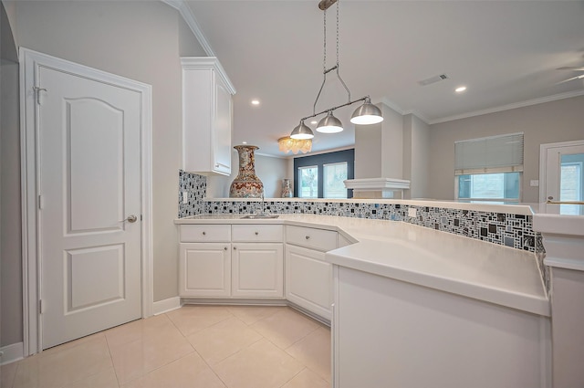 kitchen with light tile patterned floors, visible vents, white cabinets, decorative backsplash, and crown molding