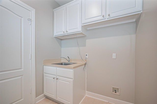 laundry room featuring hookup for a washing machine, light tile patterned flooring, a sink, and baseboards