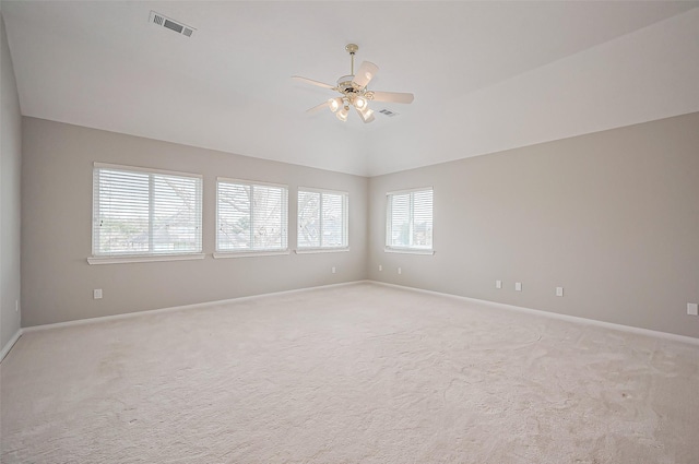 unfurnished room with light carpet, baseboards, visible vents, a ceiling fan, and lofted ceiling