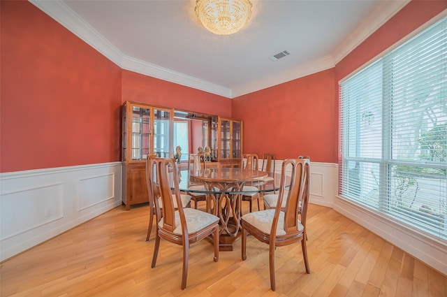 dining area featuring light wood finished floors, visible vents, and a healthy amount of sunlight