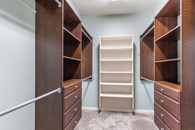 walk in closet with carpet