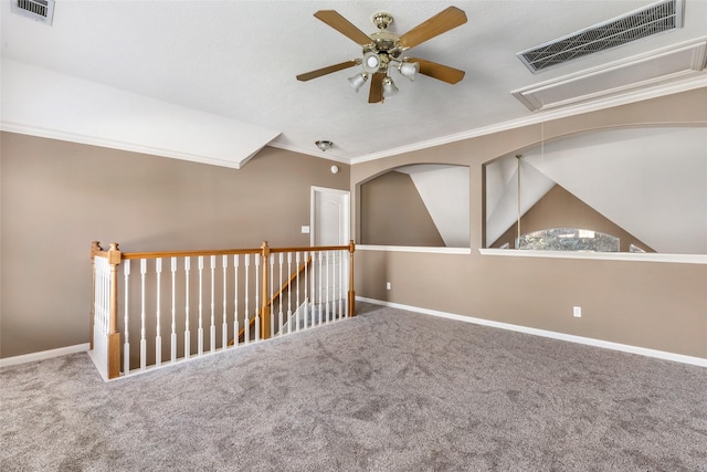 carpeted spare room with baseboards, visible vents, and crown molding