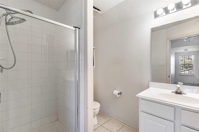 bathroom featuring a stall shower, visible vents, toilet, tile patterned floors, and vanity