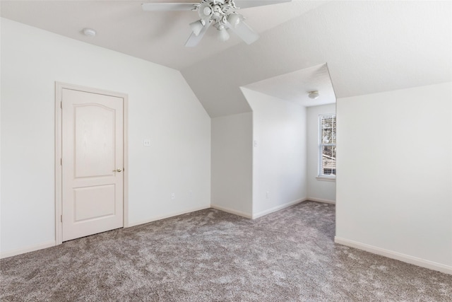 bonus room with lofted ceiling, carpet flooring, ceiling fan, and baseboards