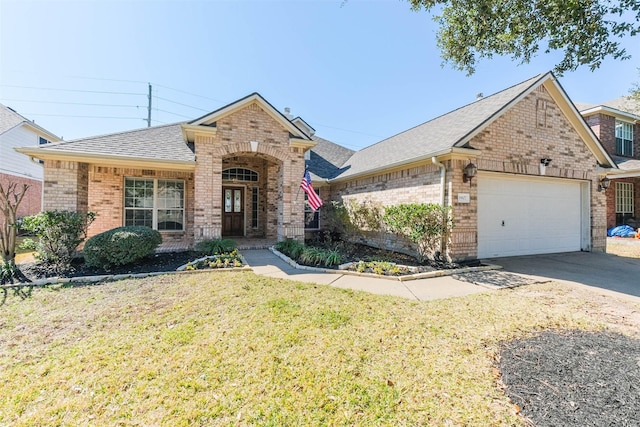 view of front of house with a garage, a front yard, concrete driveway, and brick siding