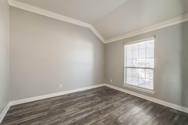 unfurnished room featuring vaulted ceiling, dark wood-type flooring, crown molding, and baseboards