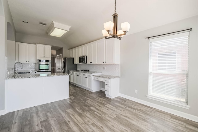 kitchen featuring a sink, white cabinetry, visible vents, light wood-style floors, and appliances with stainless steel finishes