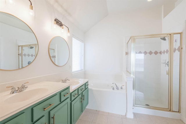 full bathroom with lofted ceiling, a sink, a garden tub, and tile patterned floors