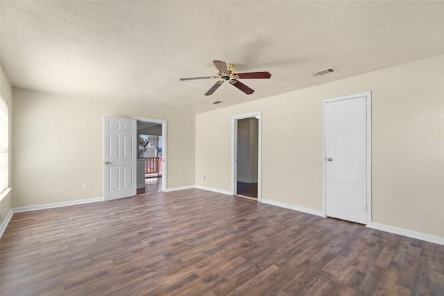 unfurnished bedroom with ceiling fan, baseboards, visible vents, and dark wood finished floors