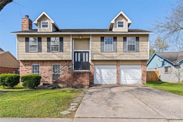 bi-level home with a front yard, brick siding, fence, and driveway