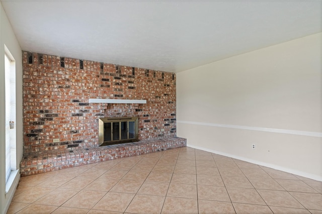 unfurnished living room with a fireplace and tile patterned floors